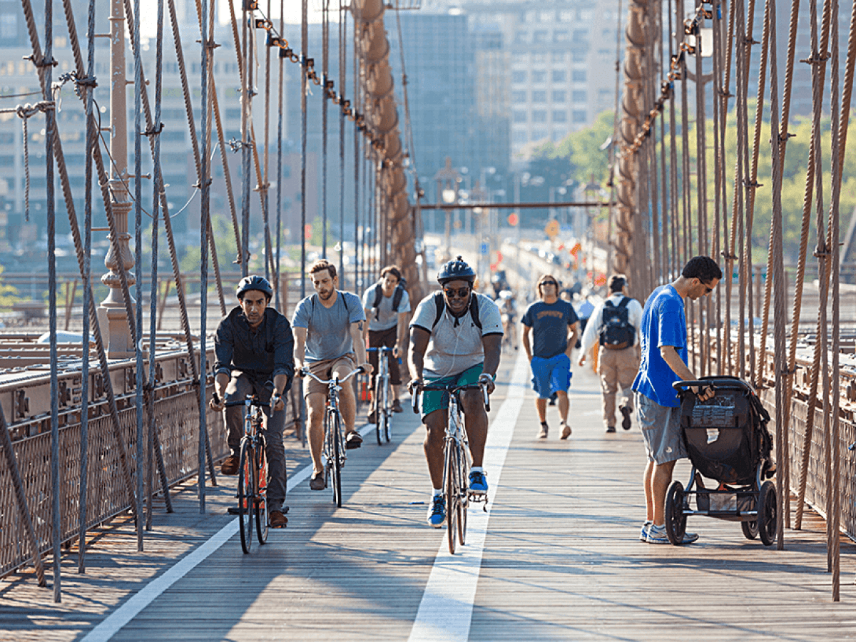 a group of people walking on a bridge