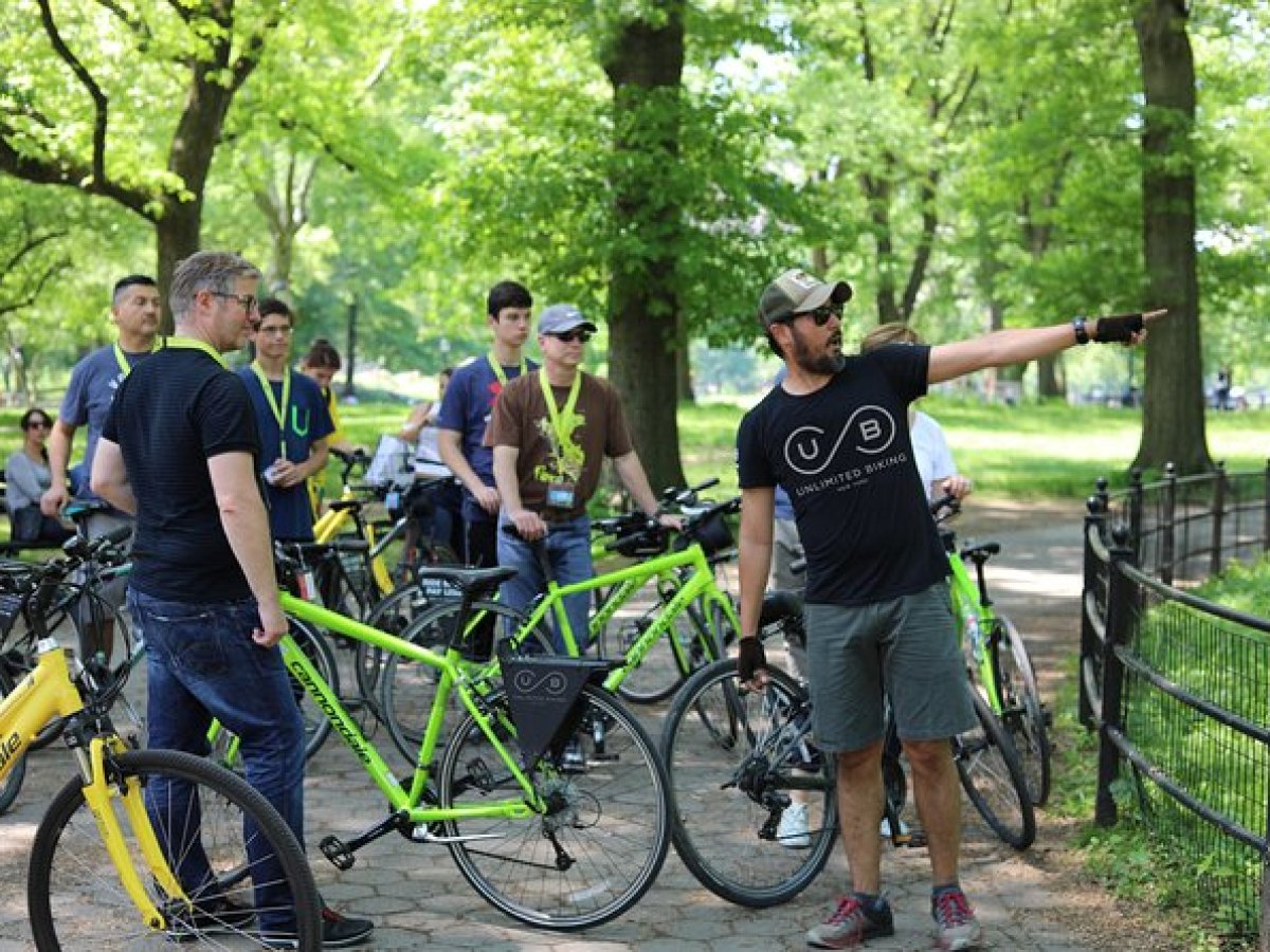 a group of people riding on the back of a bicycle