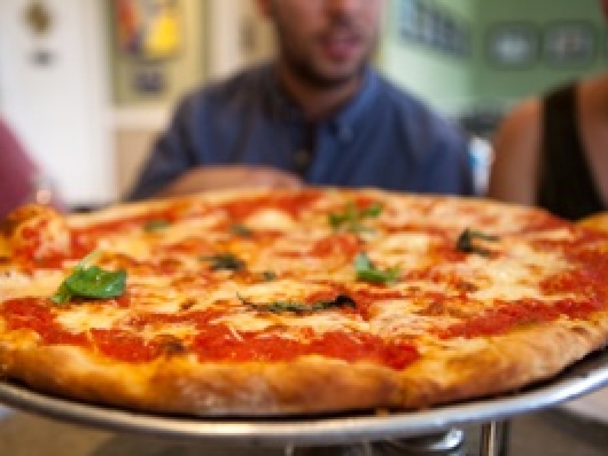 a pizza sitting on top of a pan on a table