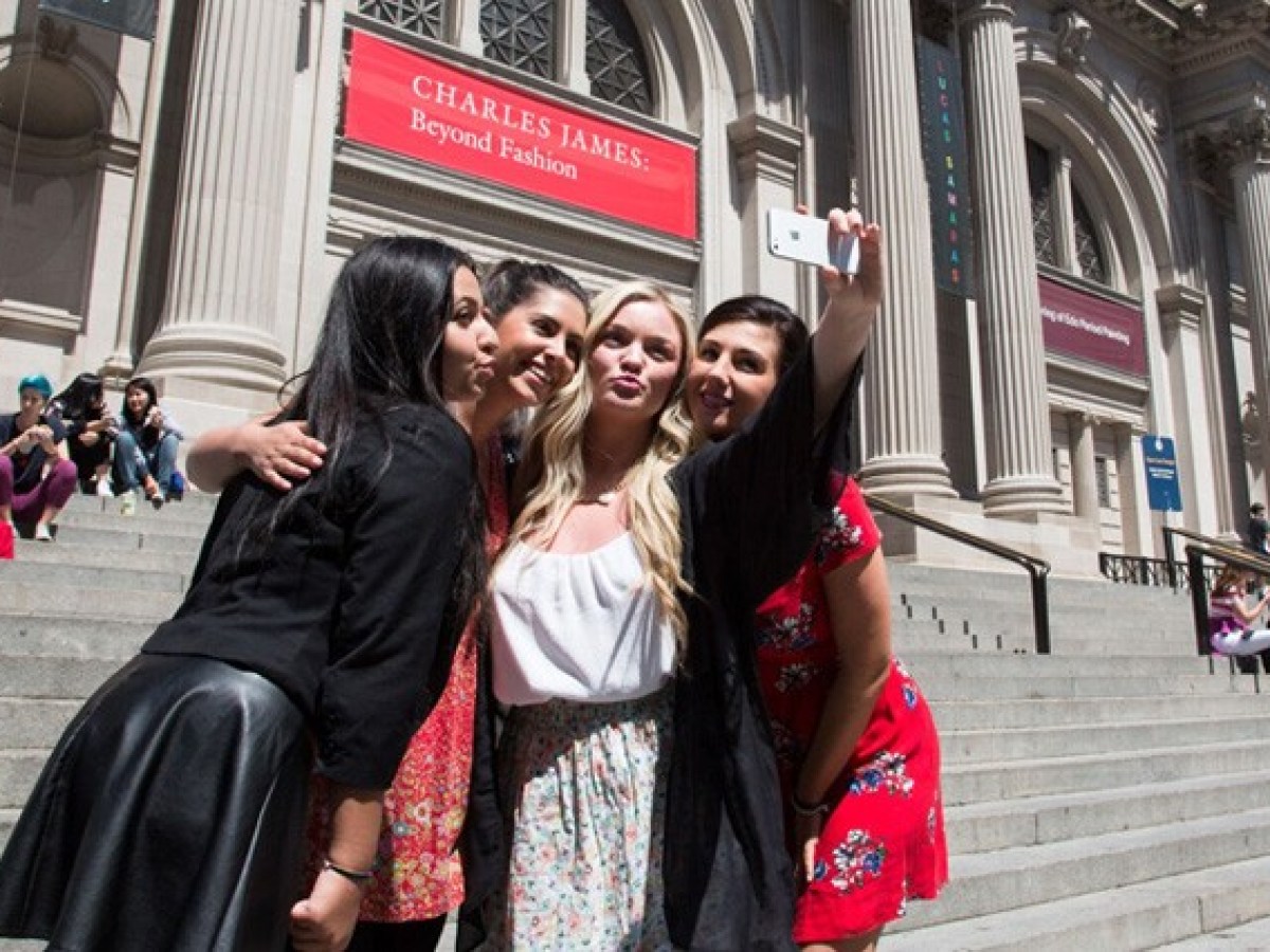 a group of people walking in front of a building