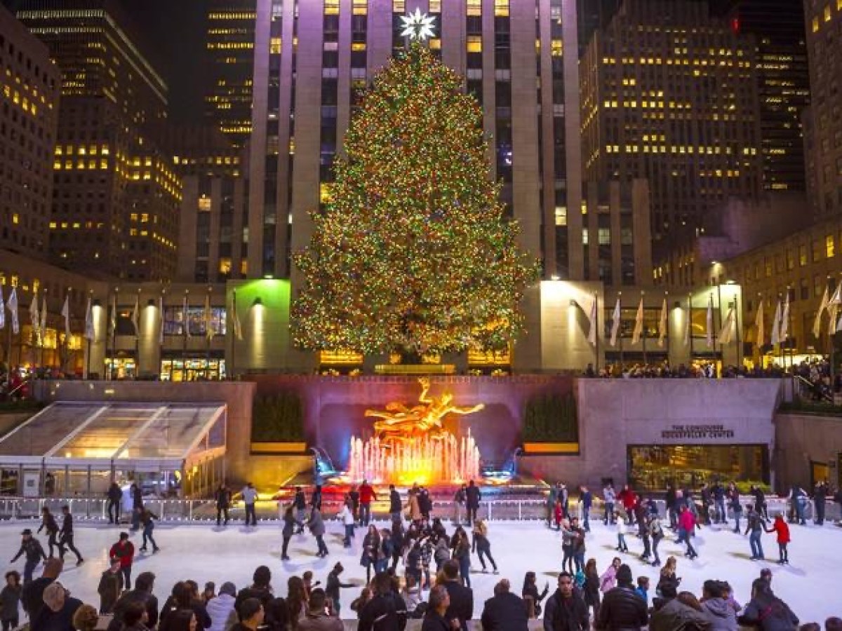 a group of people walking on Rockefeller Center street