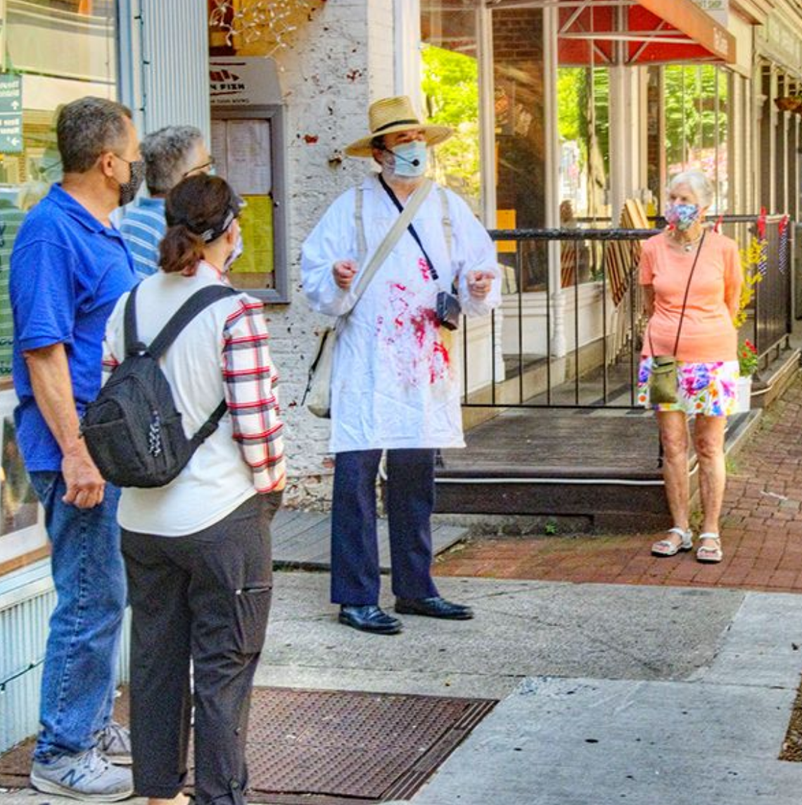 a group of people standing on a sidewalk
