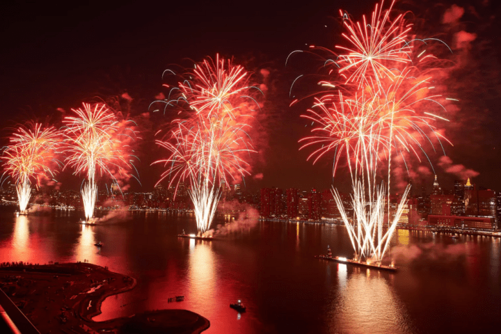 fireworks in the night sky over a body of water